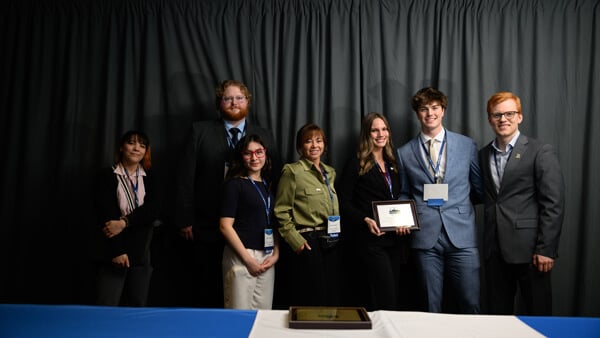 Poster Session awardees gather on stage with their award at the Forum Awards Ceremony.