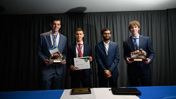 Poster Session awardees gather on stage with their award at the Forum Awards Ceremony.