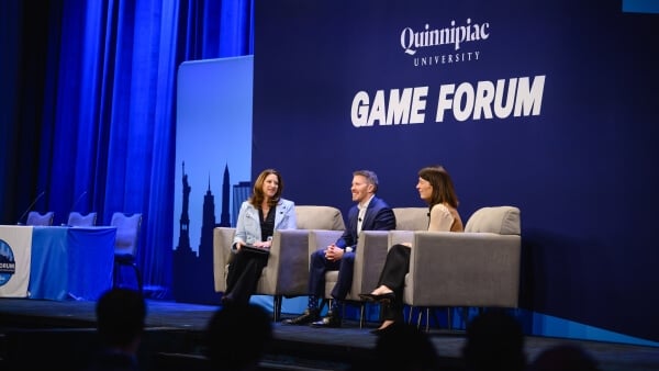 Dean Holly Raider moderates a panel of executives on the GAME Forum stage.