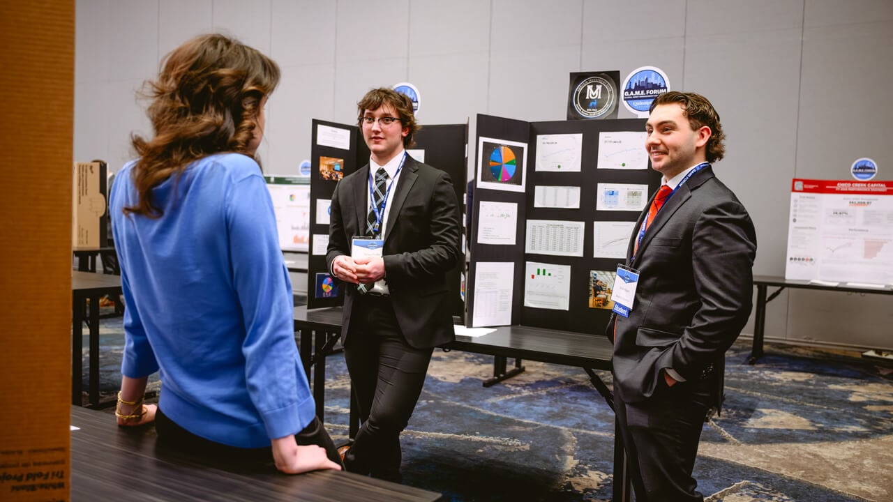 2026 Forum attendees explore portfolio poster presentations from participating universities.
