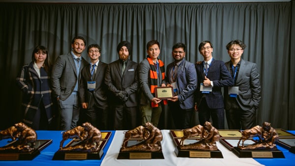 Students recognized as awardees in the Undergraduate Fixed Income category pose with their award during the Forum Poster Competition Awards Ceremony.