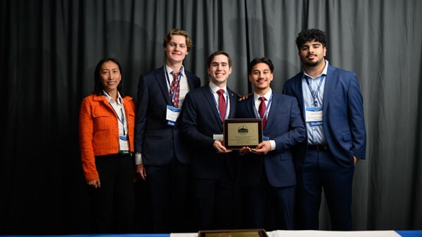 Poster Session student and faculty awardees gather on stage with their award at the Forum Awards Ceremony.