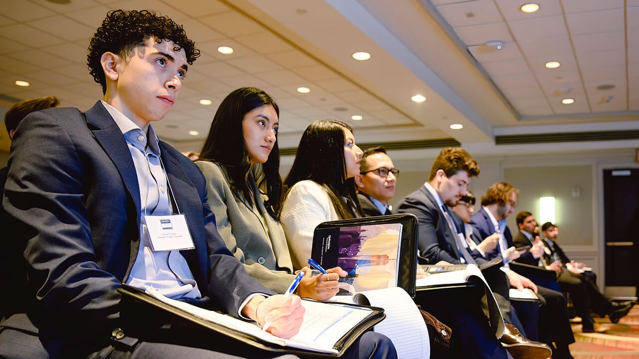 Students attend and participate in a panel discussion