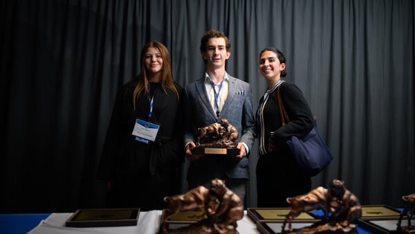 Awardees representing the Undergraduate Value category stand on stage with their certificate at the Forum Poster Competition.