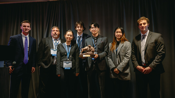 Student participants in the Graduate Overall category gather on stage with their award at the GAME Forum Awards Ceremony.