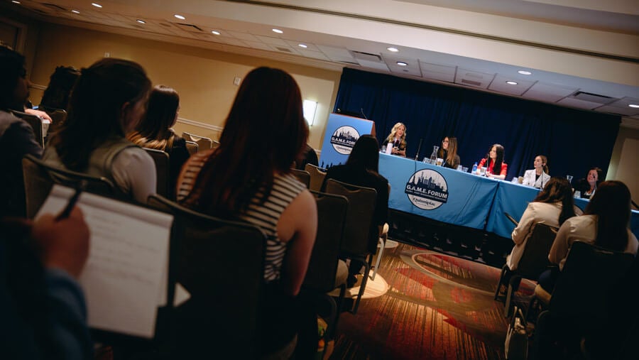 Business students attend a panel at the GAME Forum.